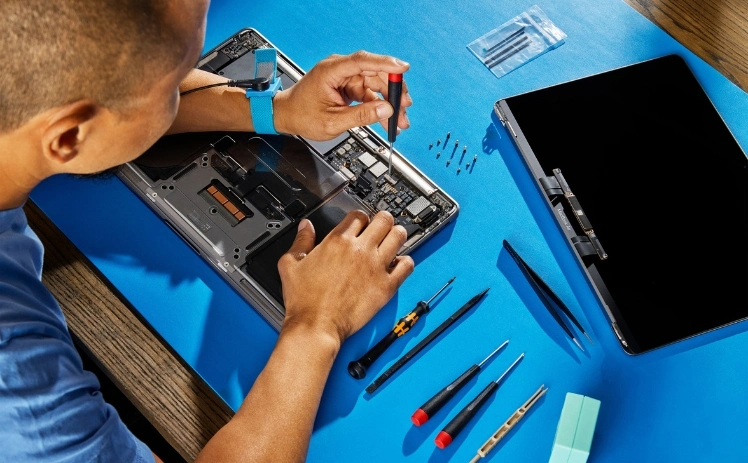 MacBook laptop being checked for repair before the new academic term