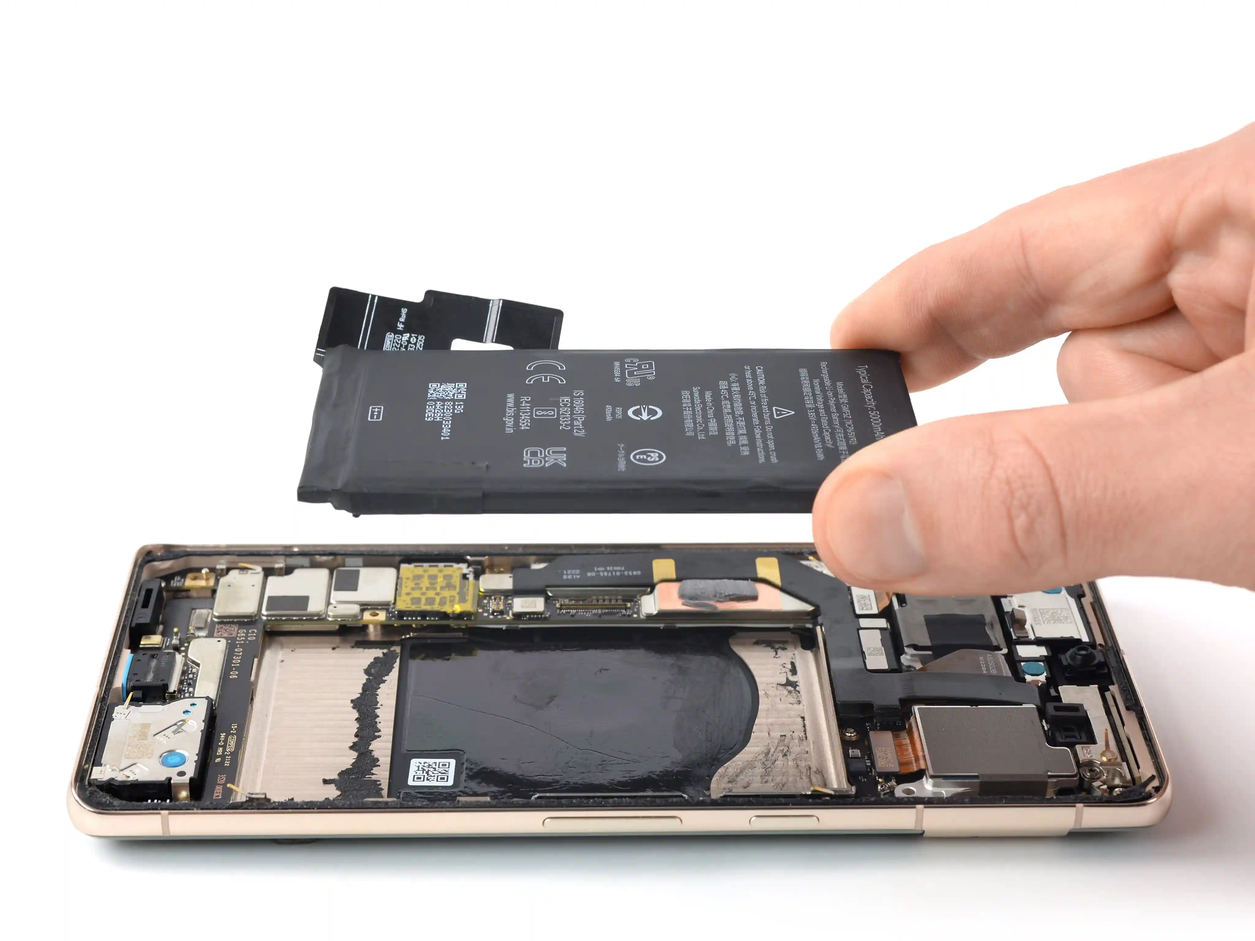 Technician removing a smartphone battery during a battery replacement